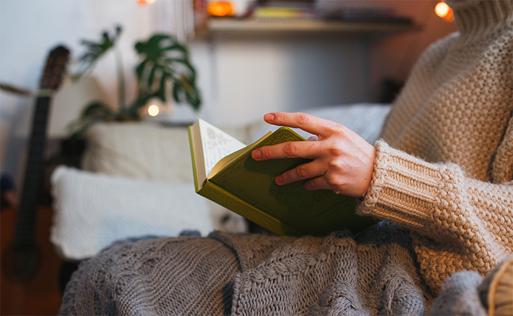 Woman reading book in she shed